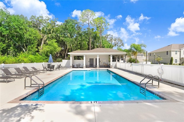 view of swimming pool with a patio area