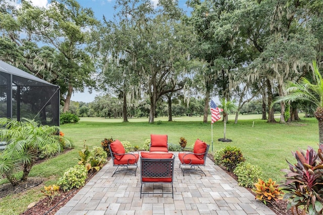 view of patio featuring a lanai