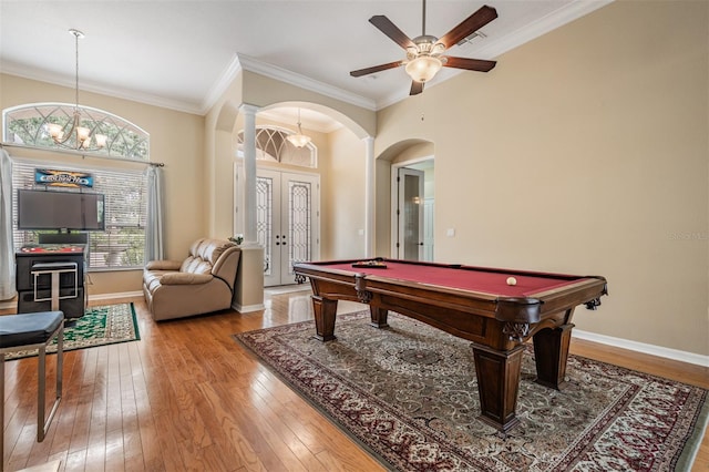 rec room with light wood-type flooring, ceiling fan with notable chandelier, billiards, crown molding, and ornate columns