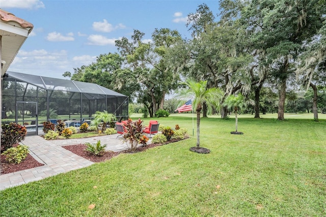 view of yard with a lanai and a patio area