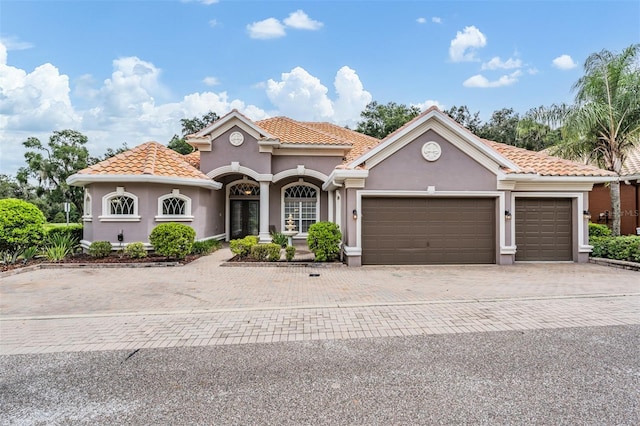 mediterranean / spanish-style home featuring a garage