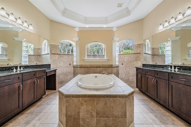 bathroom featuring a sink, a garden tub, a raised ceiling, tile patterned flooring, and ornamental molding