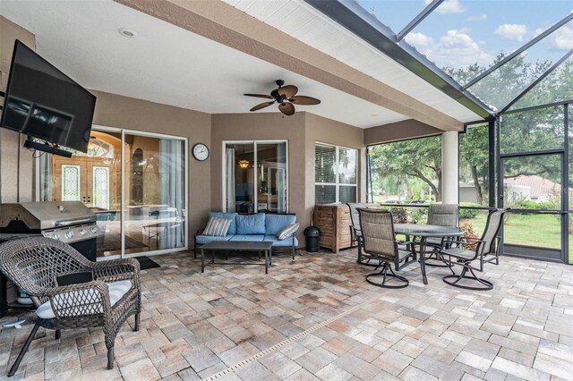 sunroom / solarium featuring ceiling fan