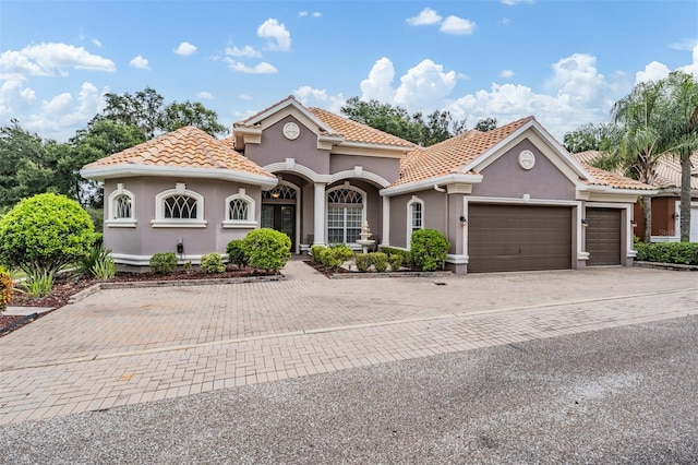 mediterranean / spanish-style house featuring a garage