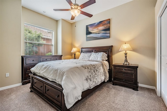 bedroom with baseboards, a ceiling fan, and light carpet
