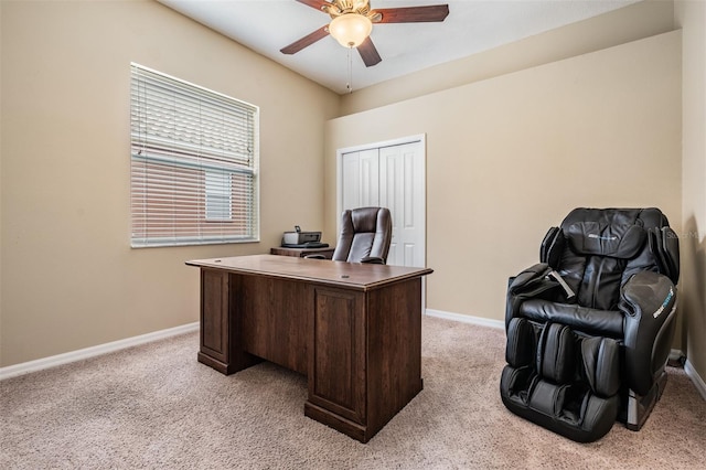 office area featuring light carpet, baseboards, and ceiling fan