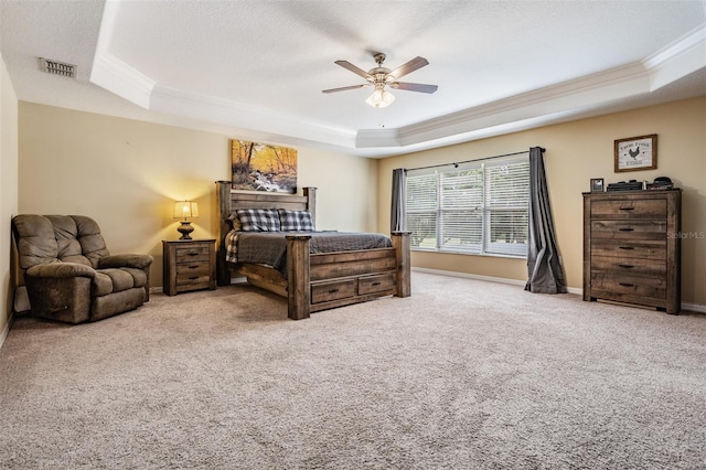 bedroom featuring a tray ceiling, ceiling fan, light colored carpet, and crown molding