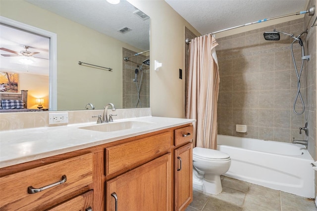 full bathroom featuring a textured ceiling, shower / tub combo, ceiling fan, vanity, and toilet