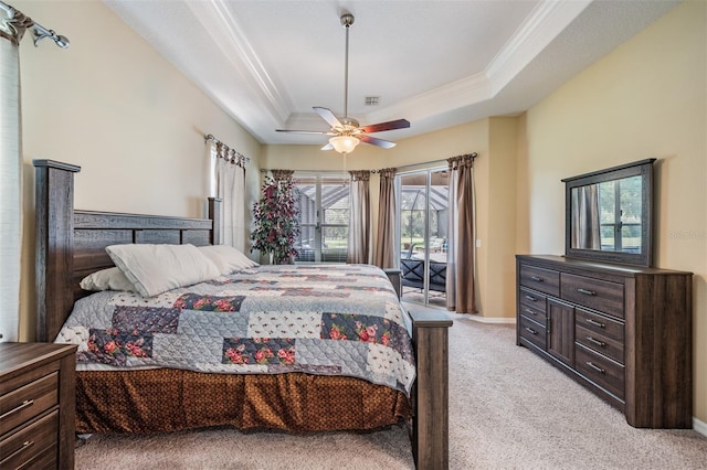 carpeted bedroom with a raised ceiling, crown molding, ceiling fan, and access to exterior