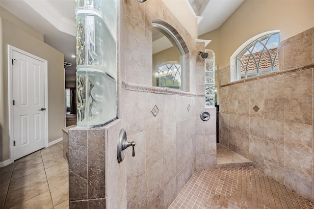 bathroom featuring tile patterned flooring and a tile shower