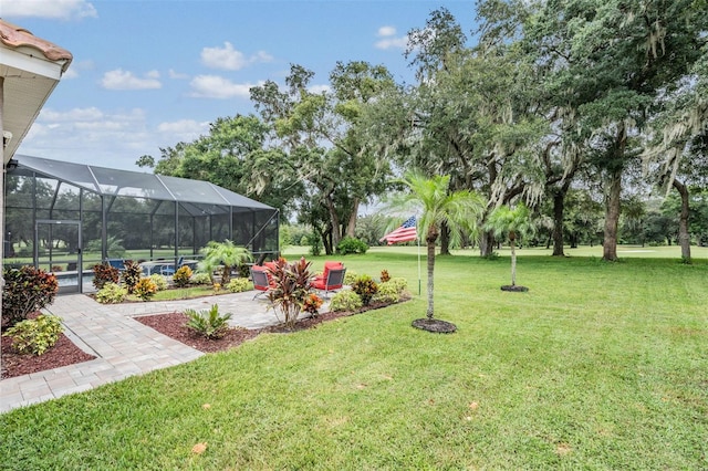 view of yard with glass enclosure, an outdoor pool, and a patio area