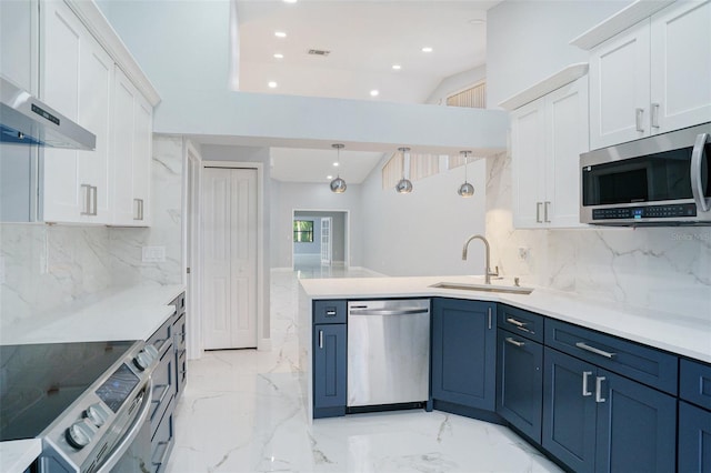 kitchen featuring white cabinetry, sink, stainless steel appliances, and decorative light fixtures