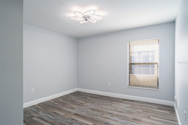 spare room with dark wood-type flooring