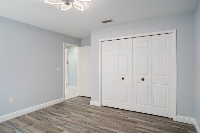 unfurnished bedroom featuring a closet and wood-type flooring