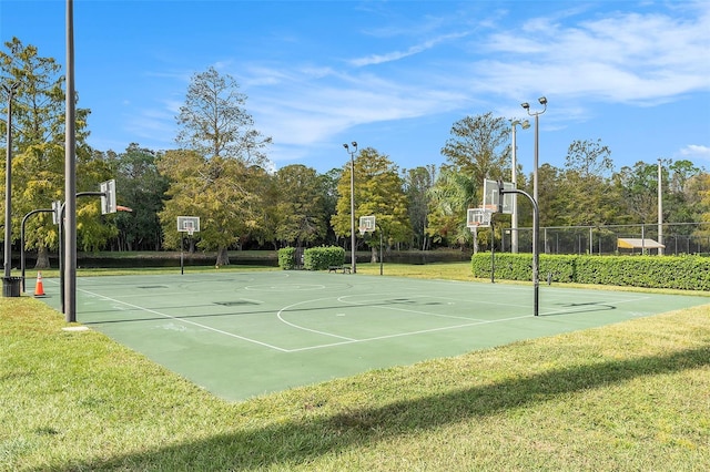 view of basketball court featuring a yard