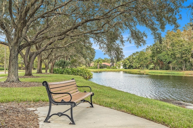 view of property's community with a water view and a yard