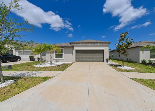 view of front of property with a front yard and a garage