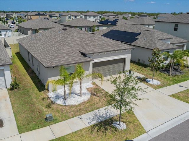 view of front of house featuring a garage and a front lawn