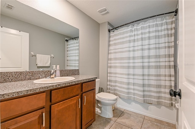 full bathroom featuring shower / bathtub combination with curtain, tile patterned floors, vanity, and toilet