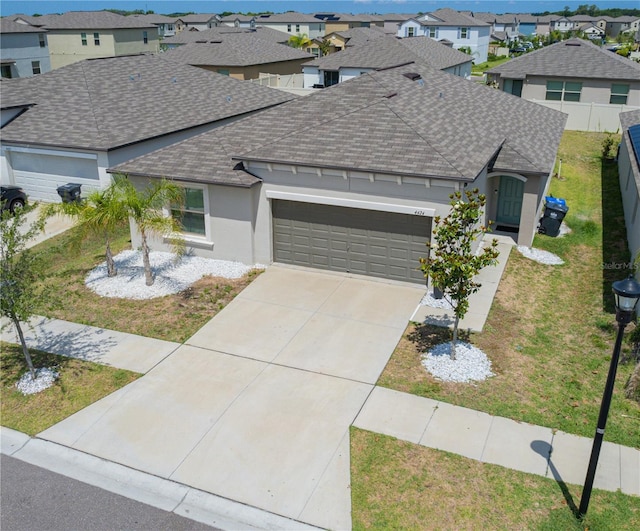 ranch-style home with a front yard and a garage