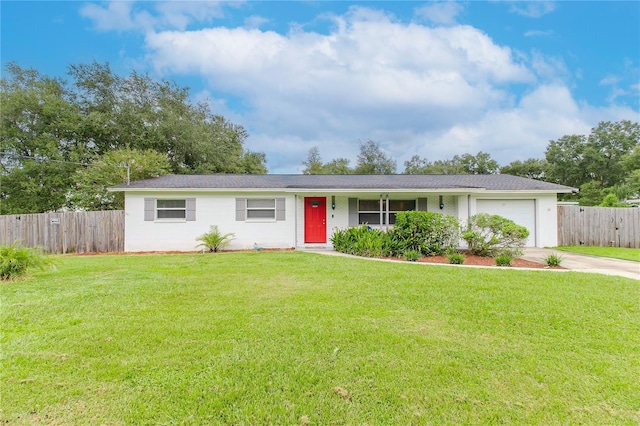 single story home featuring a garage and a front lawn