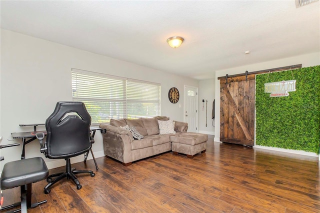 office space with dark wood-type flooring and a barn door