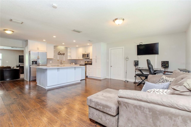 living room with dark hardwood / wood-style floors and sink