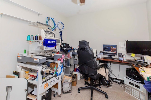 carpeted home office featuring ceiling fan