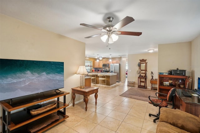 tiled living room with ceiling fan