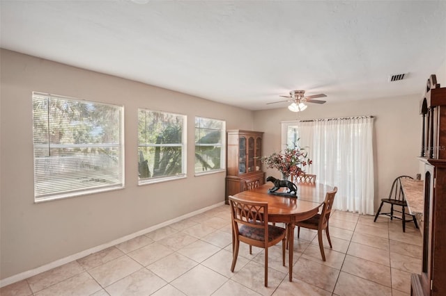 dining area featuring ceiling fan and light tile patterned floors