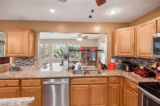 kitchen featuring ceiling fan, backsplash, sink, and light stone counters