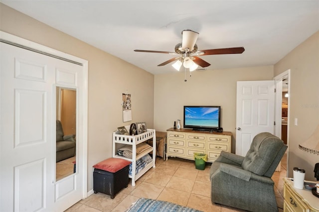 sitting room with ceiling fan and light tile patterned floors