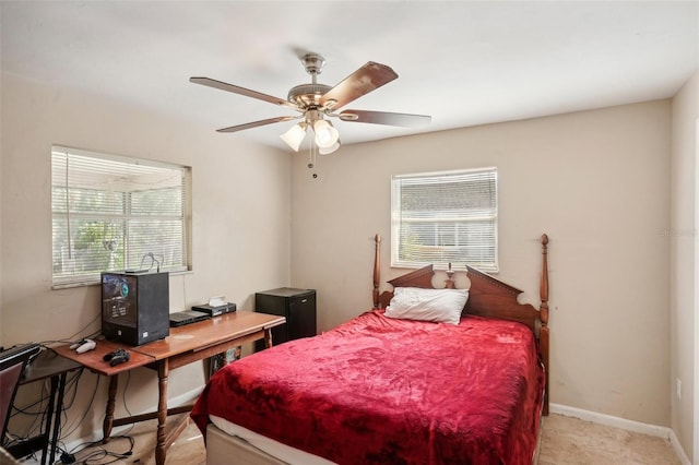 bedroom with multiple windows and ceiling fan