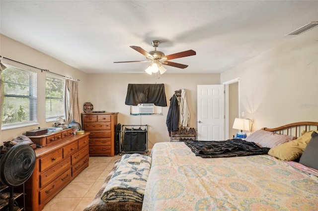 bedroom with cooling unit, ceiling fan, and light tile patterned floors