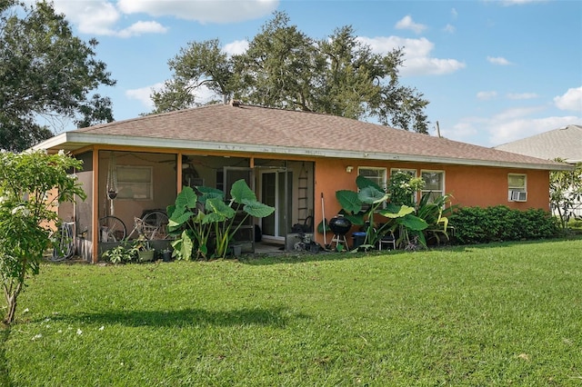 back of property featuring a yard