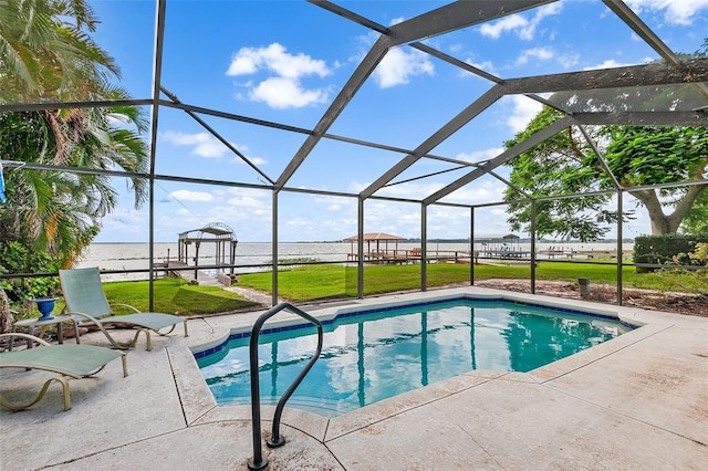 view of swimming pool featuring a lanai, a patio, a lawn, and a water view