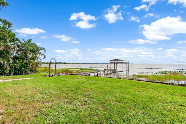 view of yard with a dock and a water view