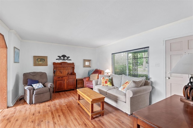 living room with light wood-type flooring and crown molding