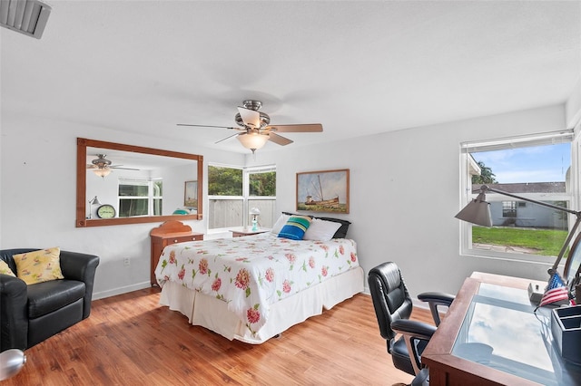 bedroom with ceiling fan and hardwood / wood-style flooring