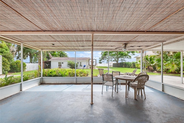 unfurnished sunroom featuring ceiling fan