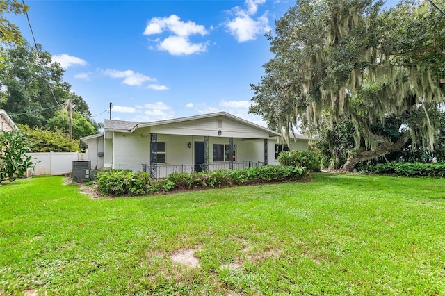 rear view of property with a porch and a yard