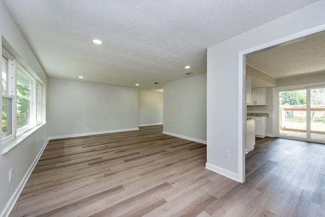 interior space featuring a textured ceiling and light hardwood / wood-style floors