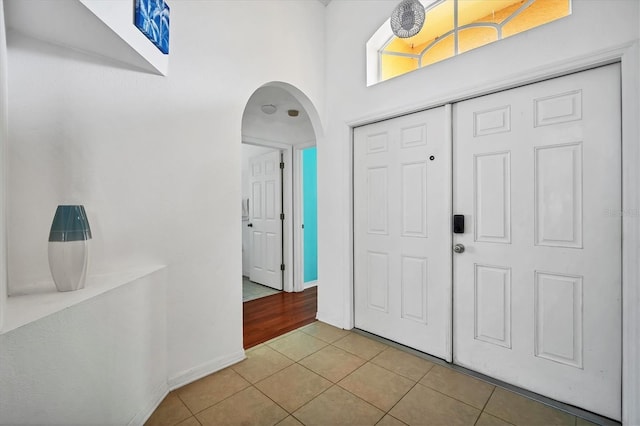 1122 Vinetree Dr, Brandon, FL 33510 - foyer with arched walkways, baseboards, and tile patterned flooring