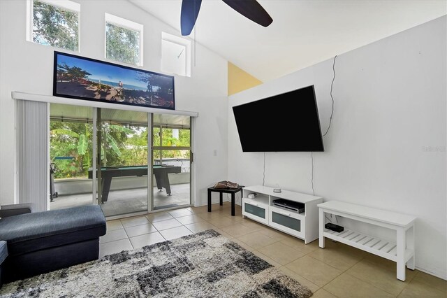 living room with ceiling fan, tile patterned flooring, high vaulted ceiling, and a healthy amount of sunlight