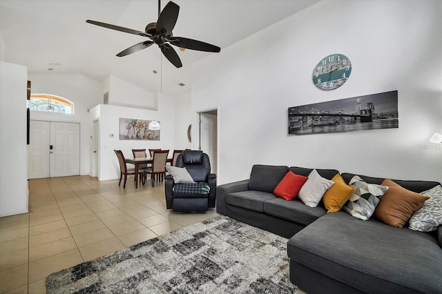 living room featuring light tile patterned floors, ceiling fan, and high vaulted ceiling