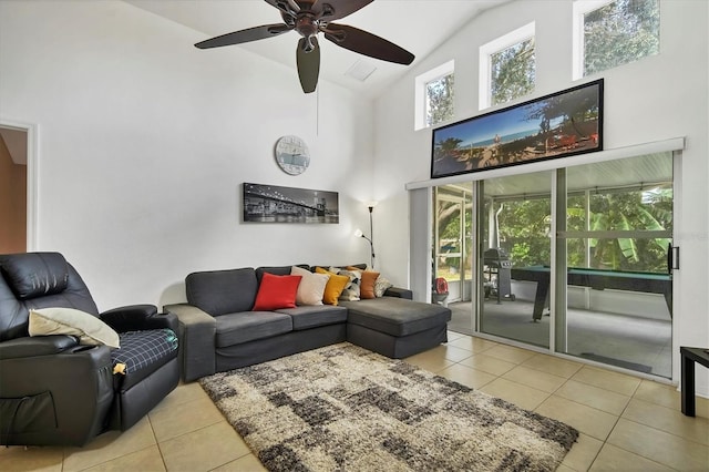 living room with ceiling fan, light tile patterned flooring, and high vaulted ceiling