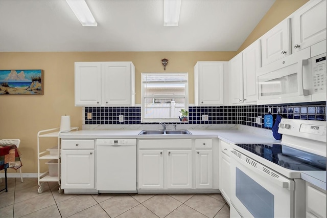 kitchen featuring decorative backsplash, sink, white appliances, and white cabinetry