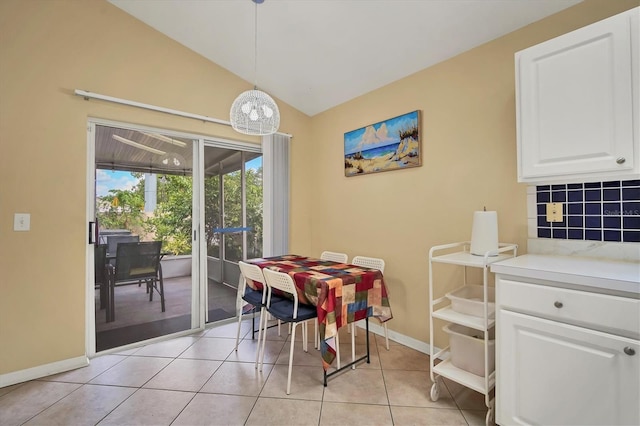 dining area featuring vaulted ceiling and light tile patterned floors