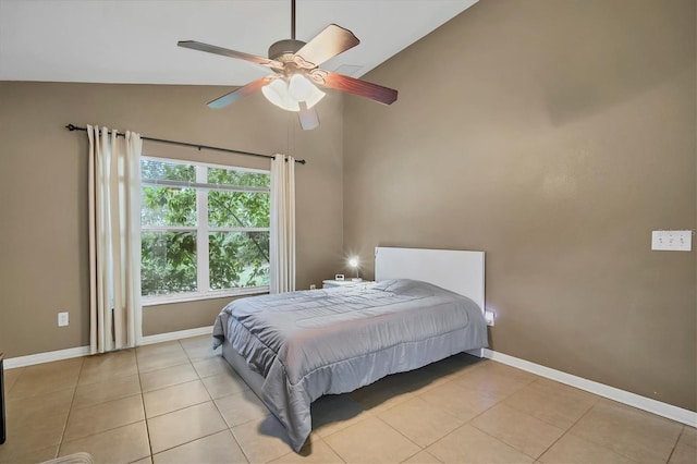 tiled bedroom with ceiling fan and high vaulted ceiling