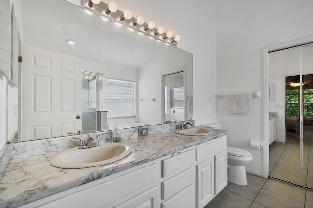 bathroom with vanity, toilet, and tile patterned floors